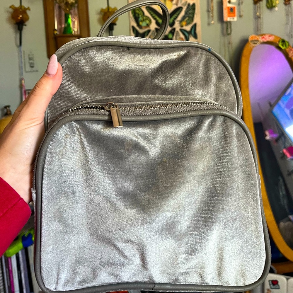 Small gray velvet backpack.